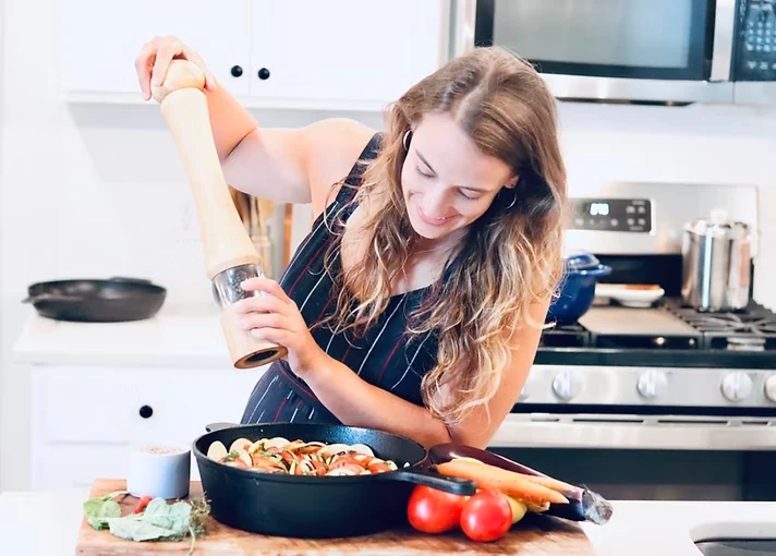 Allie preparing a colorful vegetable dish in her kitchen