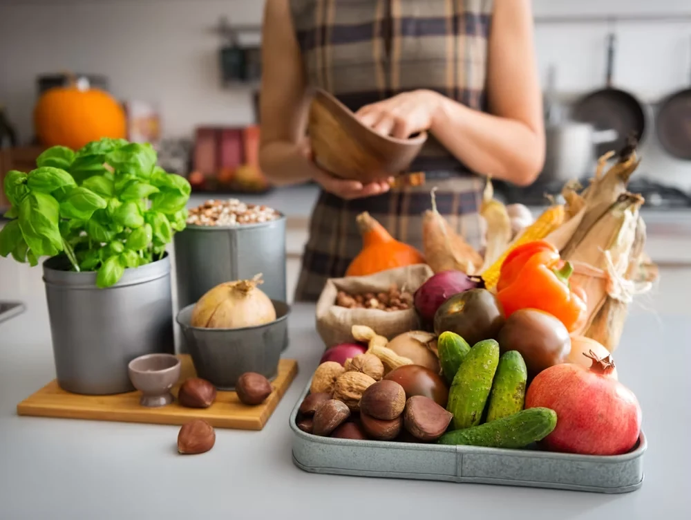 A relaxed kitchen table filled with fresh produce